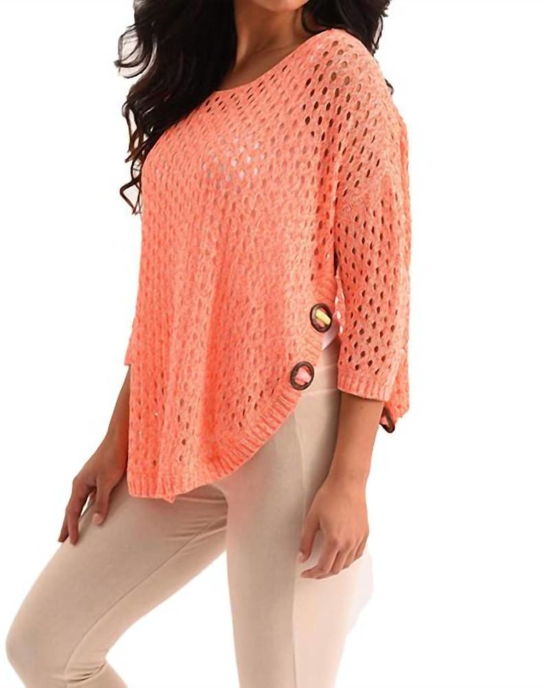Front of a model wearing a size XXL Aimee Wooden Button Poncho in Melon in Melon by french kyss. | dia_product_style_image_id:325674